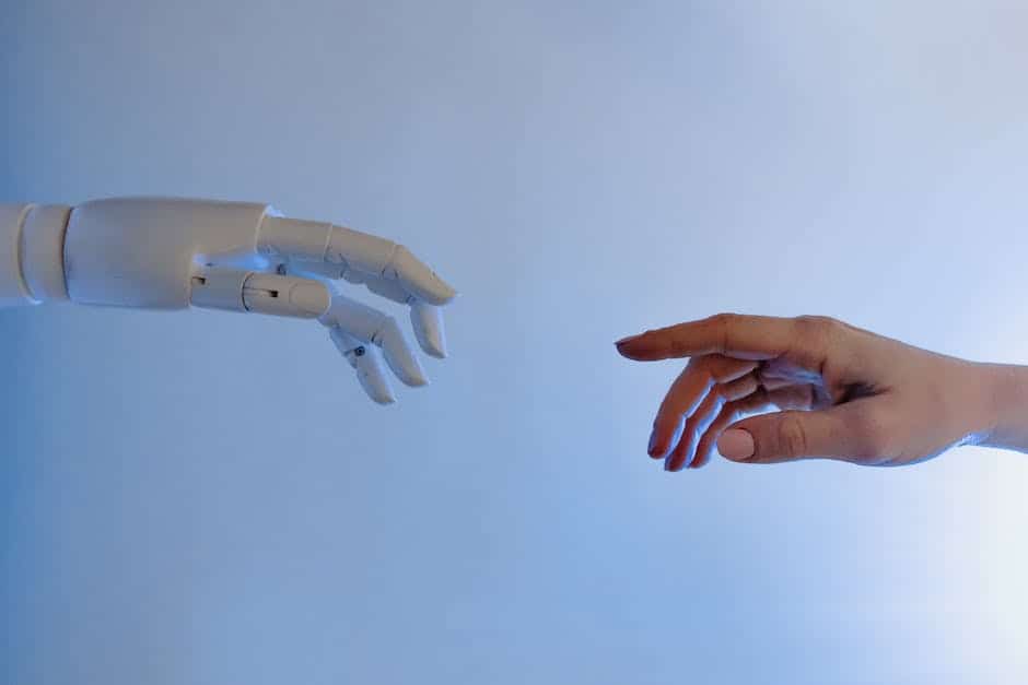 A robot reaching out to a human hand.