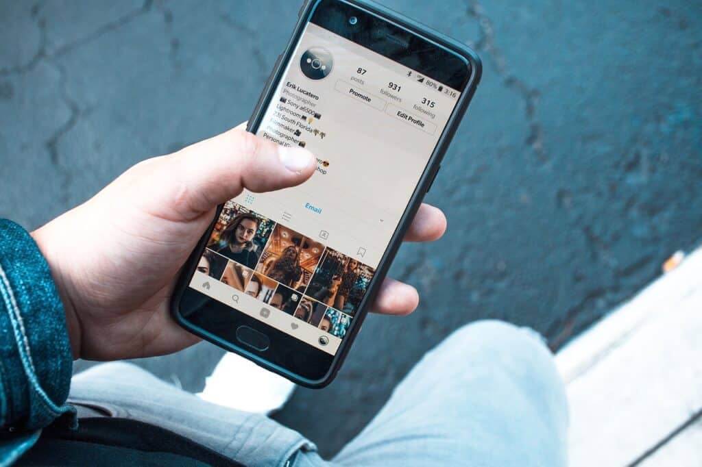 A person holding a cell phone with an instagram picture on it.