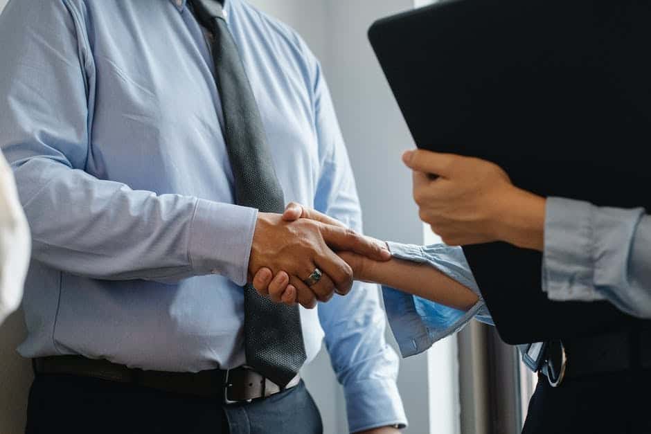 Two business people shaking hands in an office.