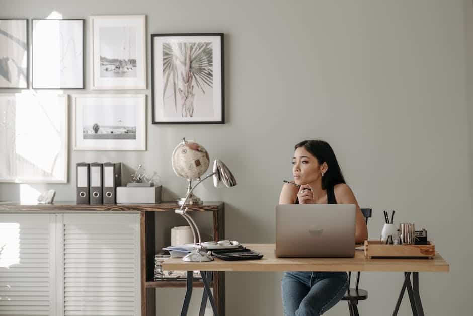 A woman sitting at a desk working on her laptop.