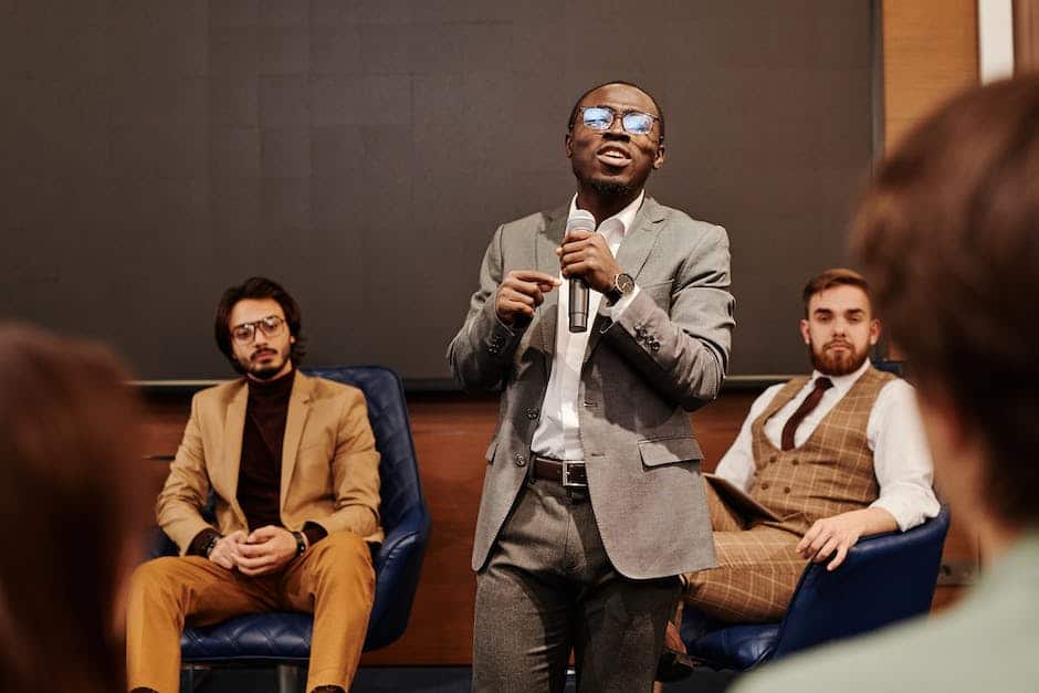 A man in a suit is giving a presentation to a group of people.