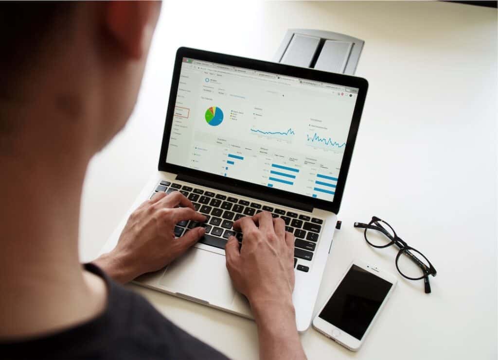 A person using a laptop with a graph on it.
